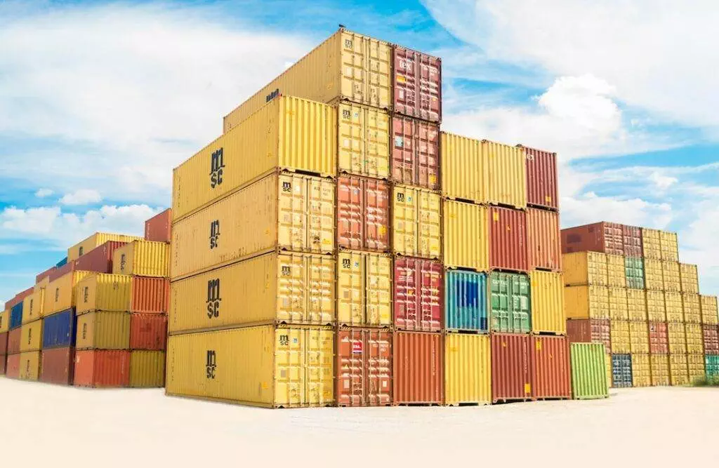 A group of containers stacked in front of a blue sky.