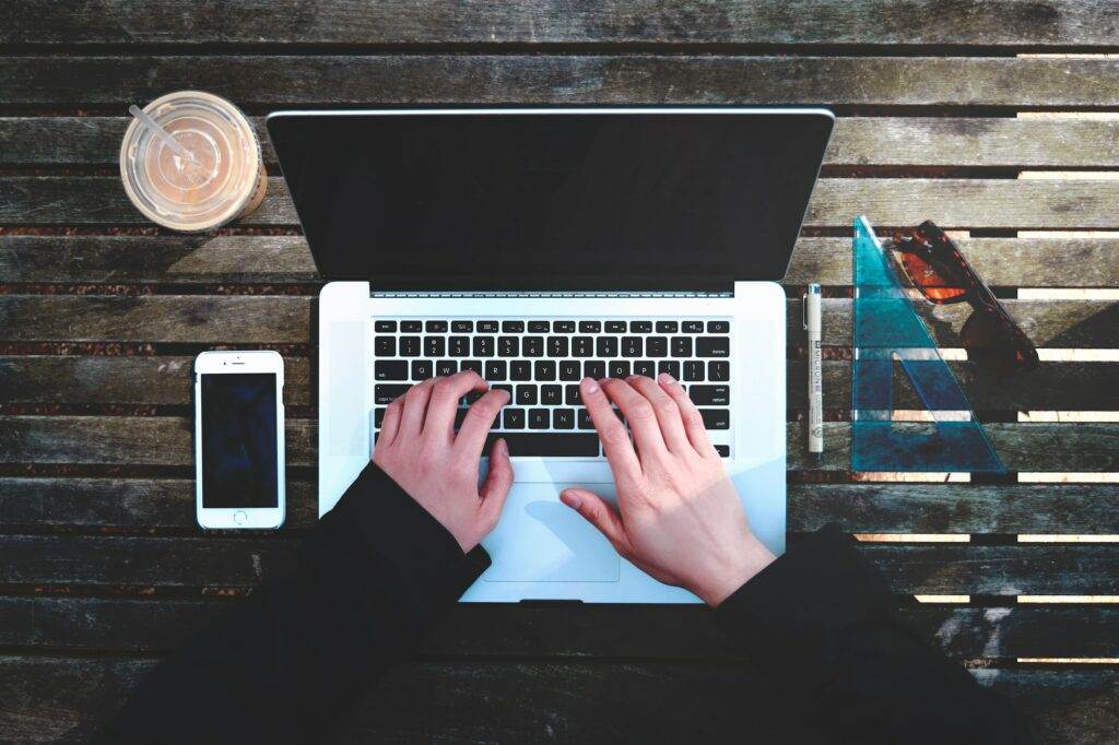 A person typing on a laptop.